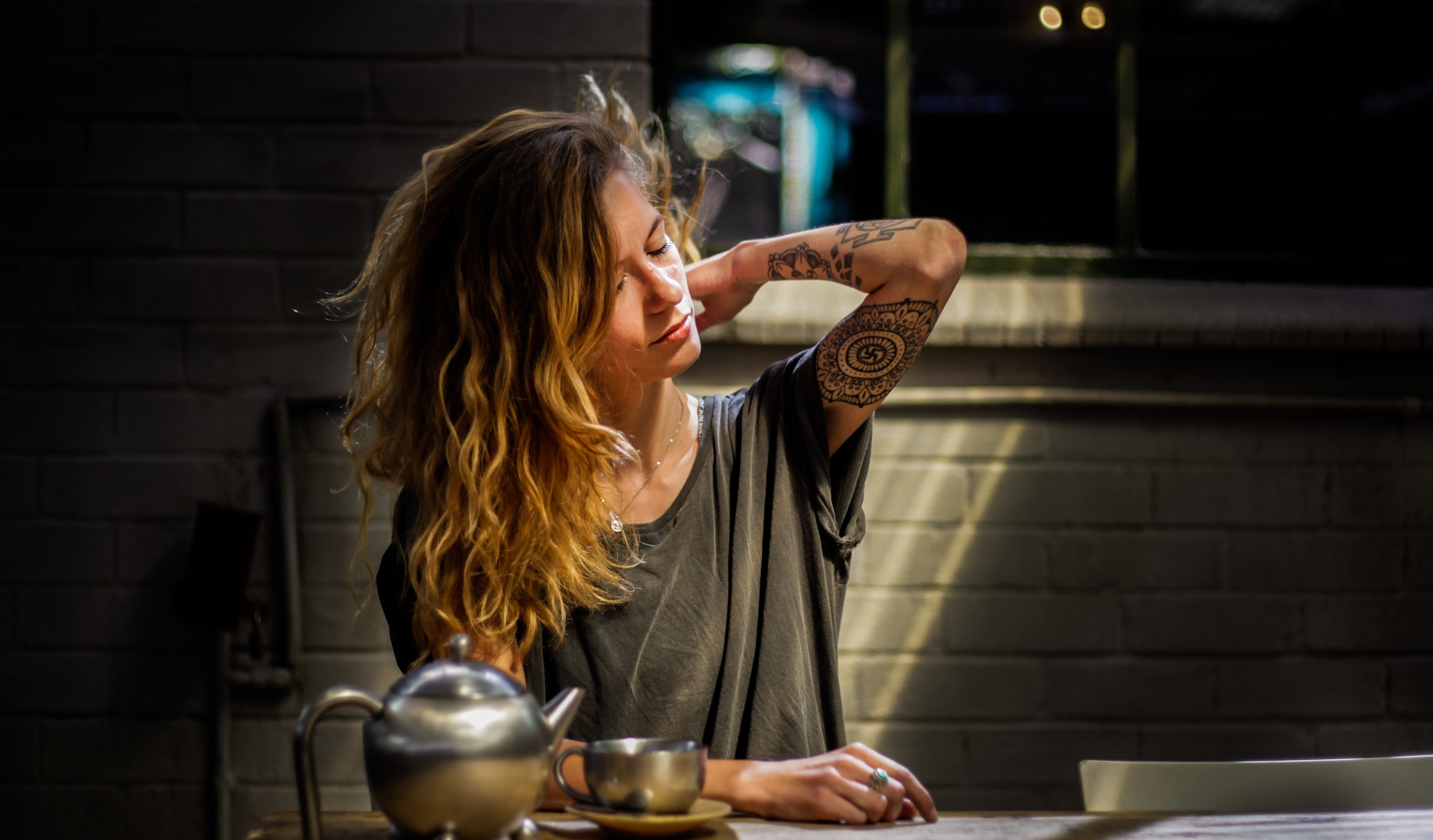 Canva - Woman Sitting Beside Table