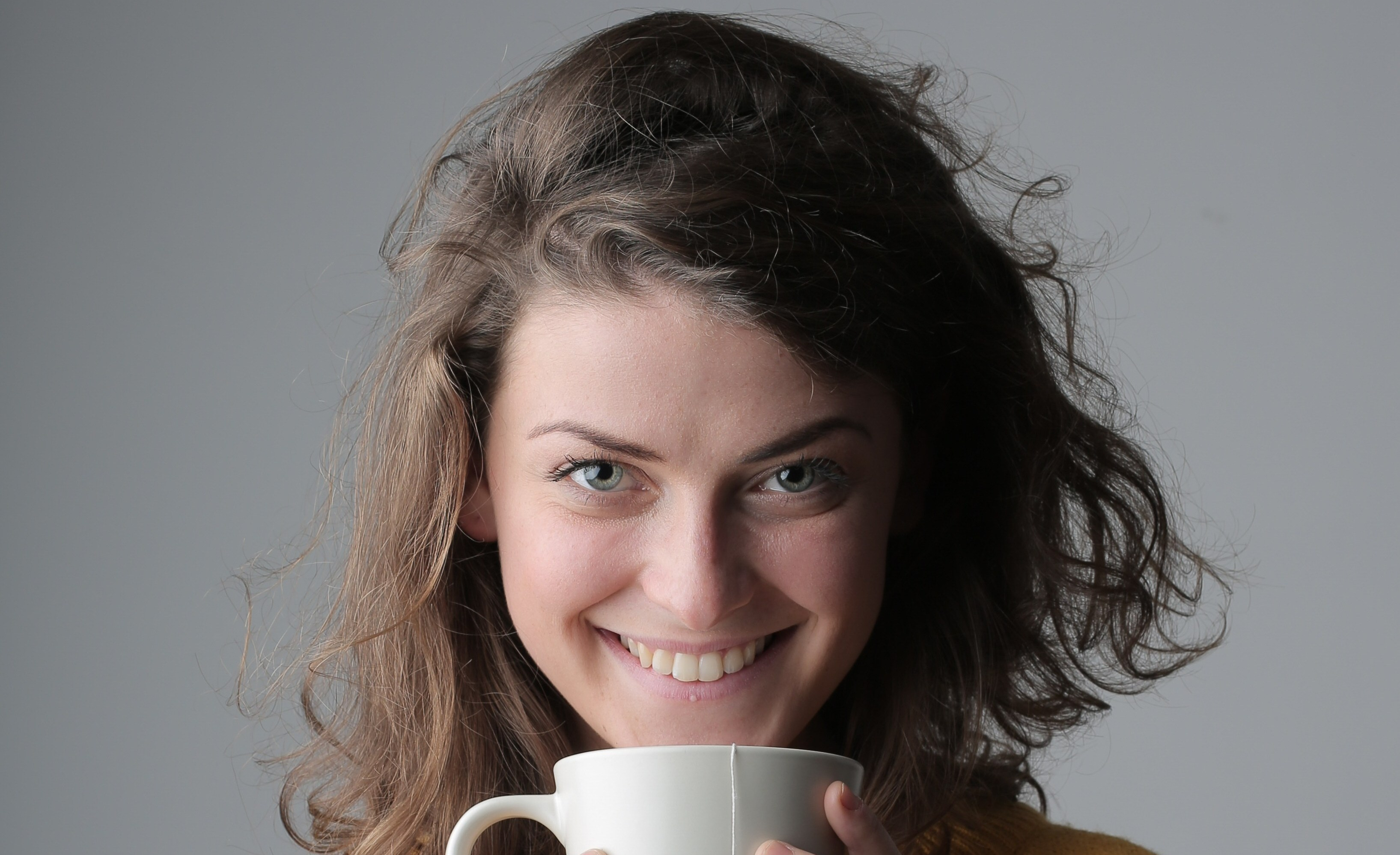 Canva - Woman in Yellow Sweater Holding White Ceramic Mug