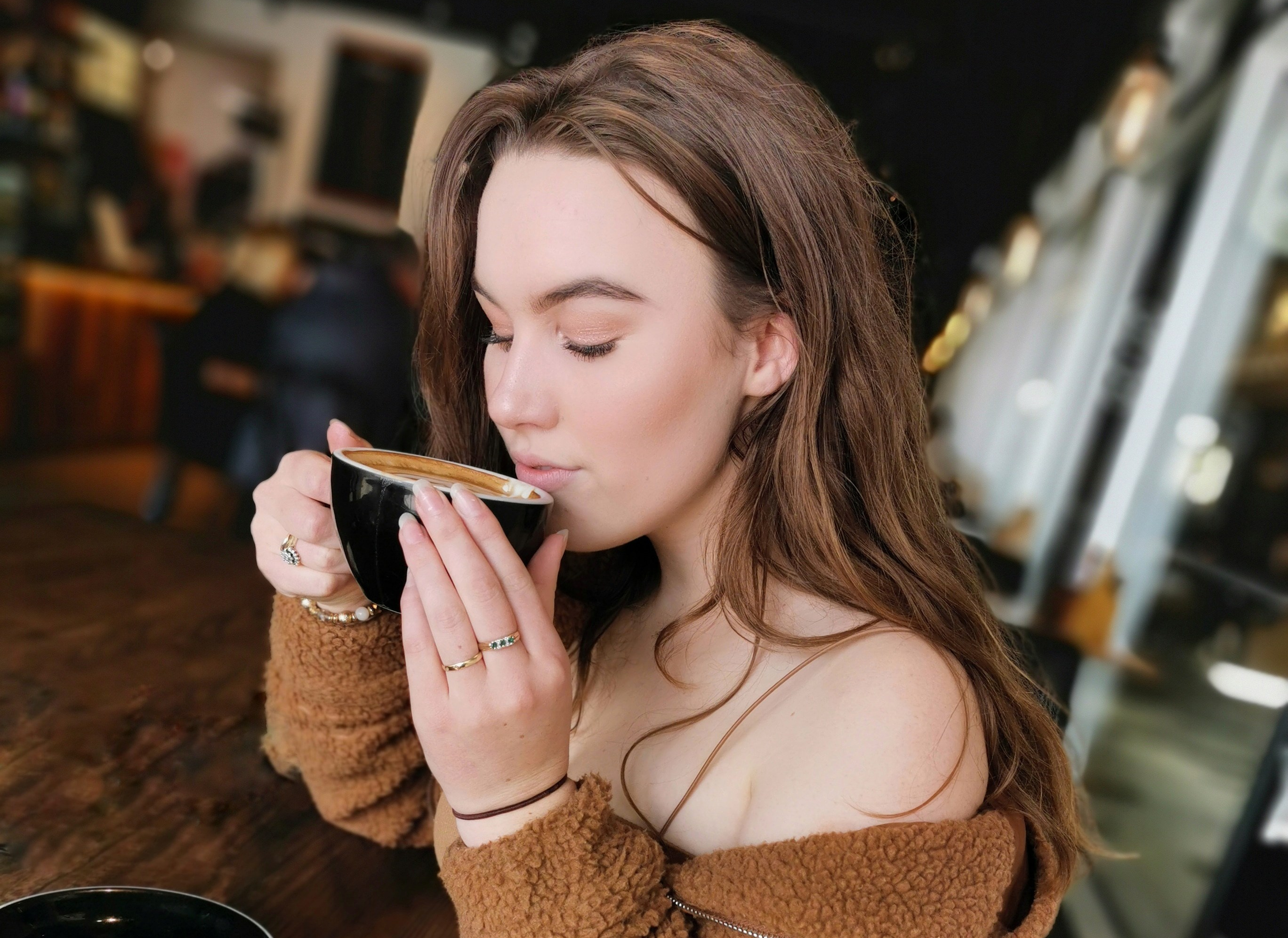 Canva - Selective Focus Photo of Woman Sitting at Table in Coffee Shop Sipping Coffee