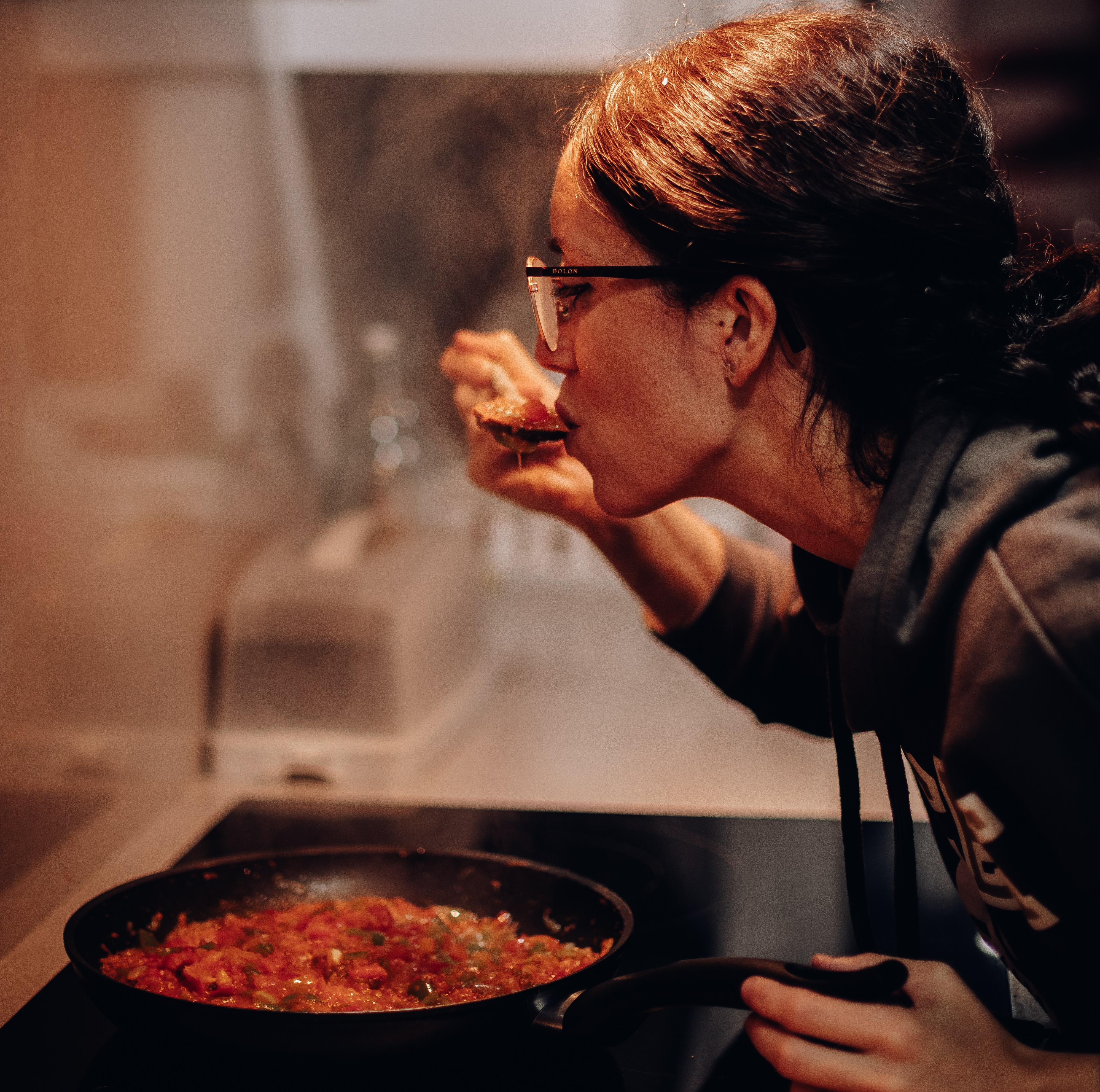Canva - Woman Eating on Cooking Pan