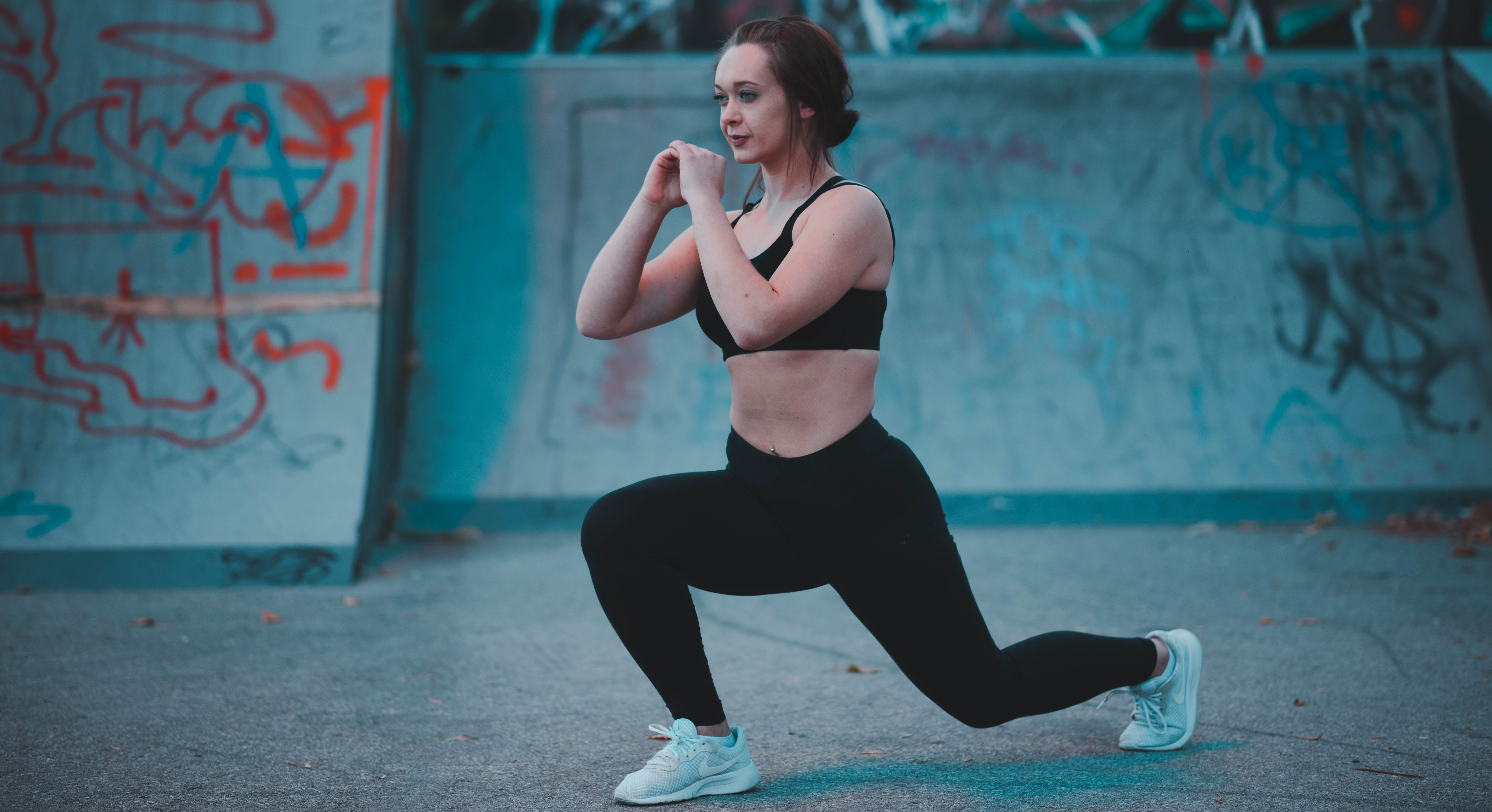 Canva - Woman Stretching Beside Wall