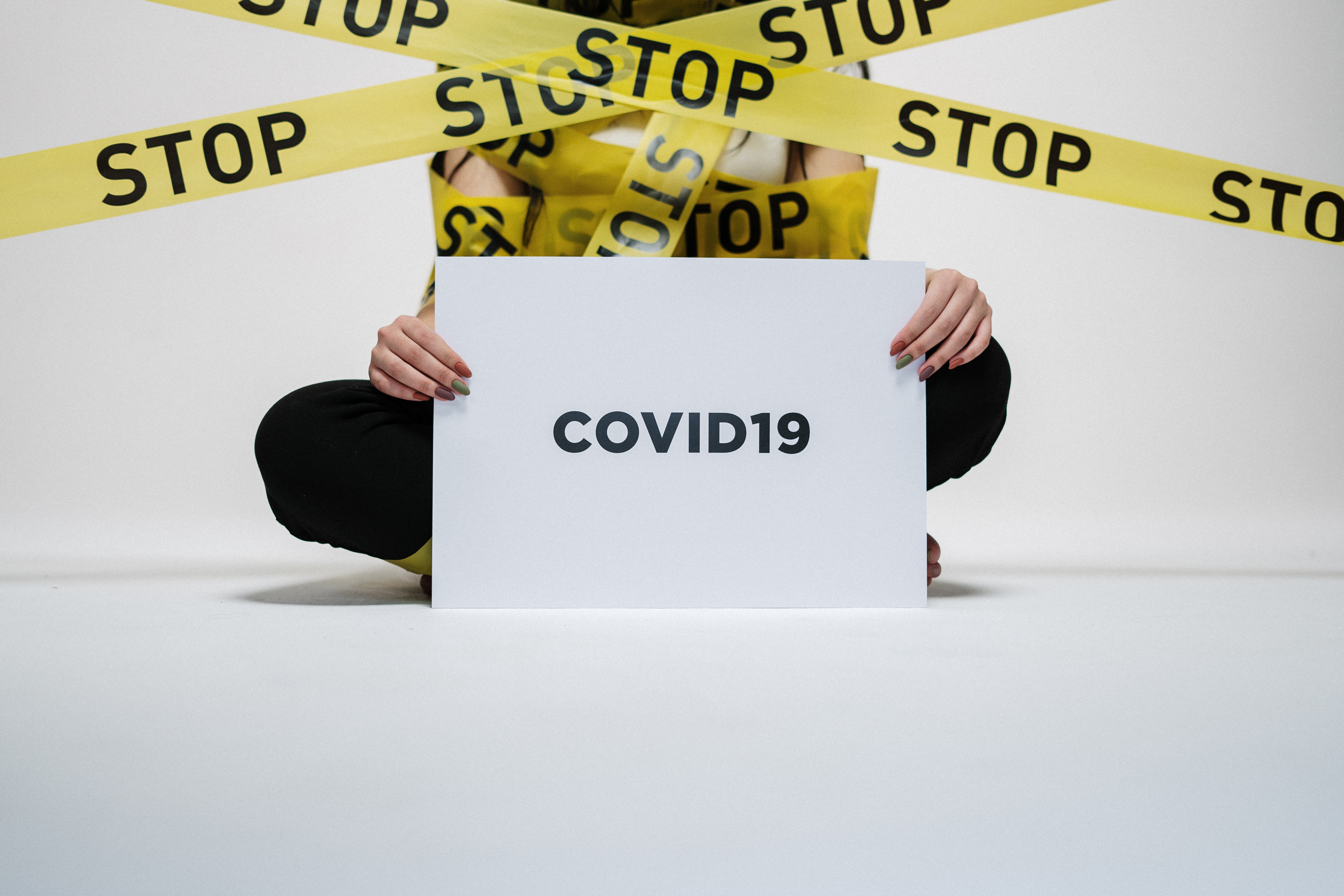 Canva - Person Holding Covid Sign