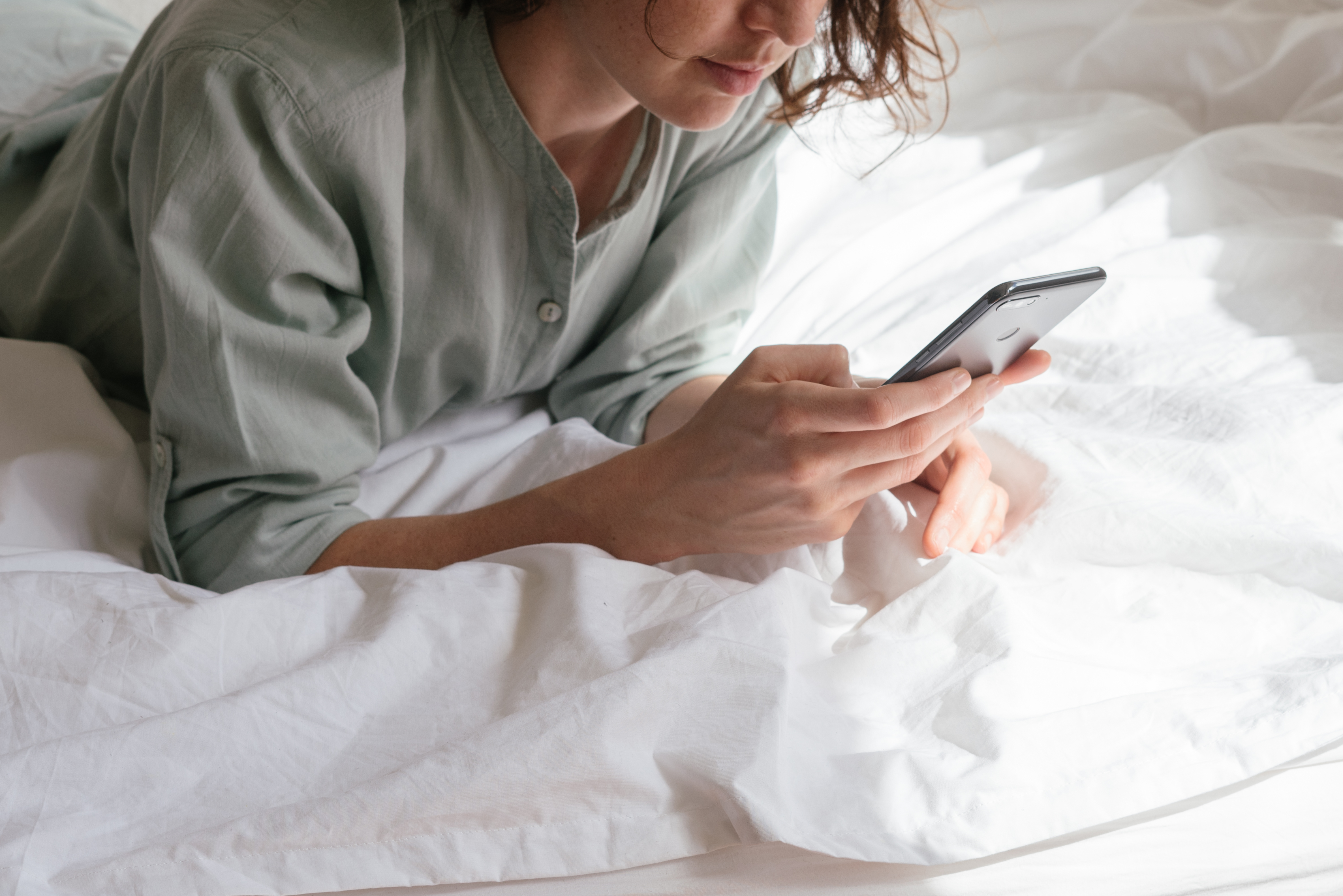 Canva - Woman Using Smartphone in Bed