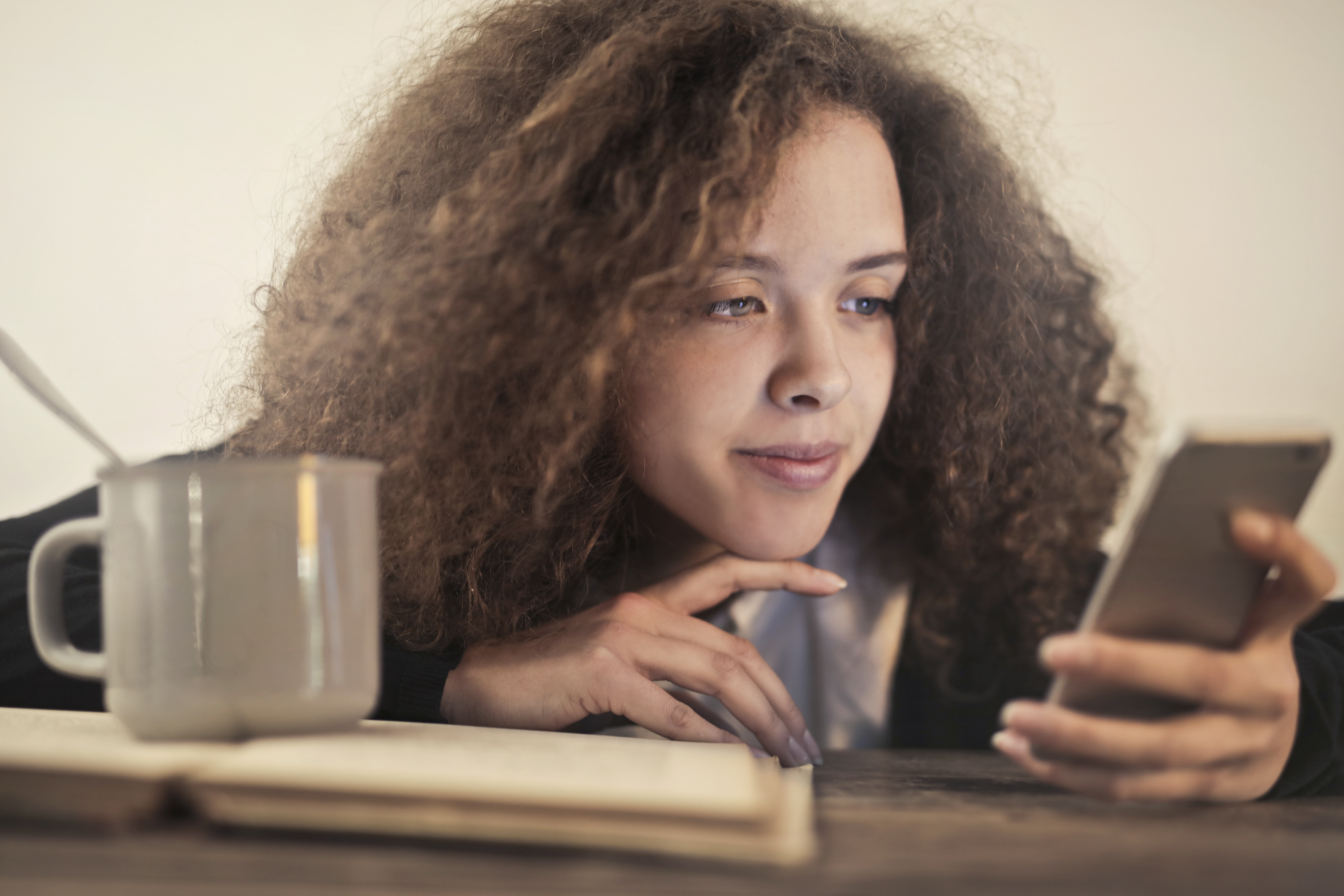 Canva - Woman in Black Shirt Leaning on Brown Wooden Table