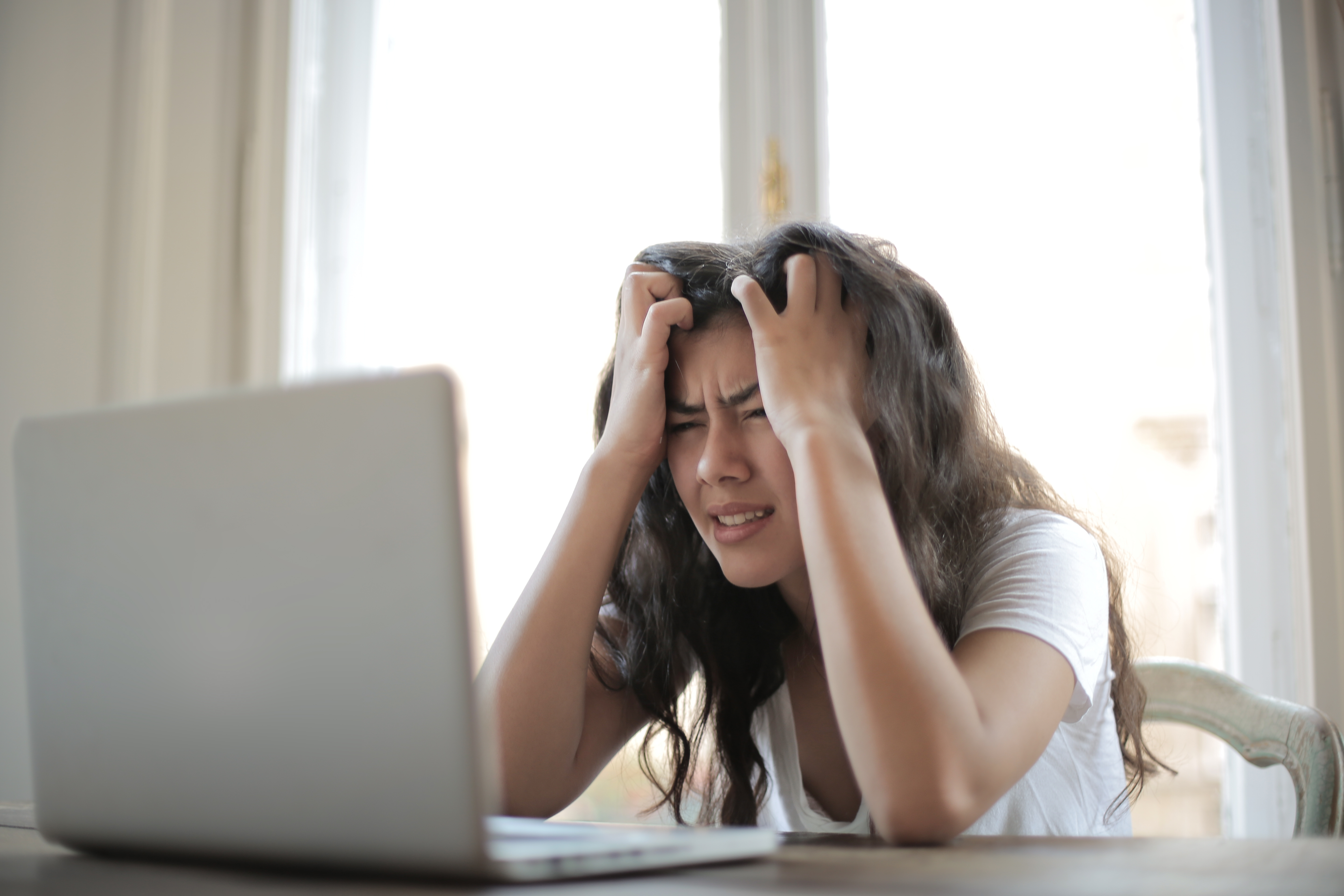 Canva - Woman in White Shirt Showing Frustration