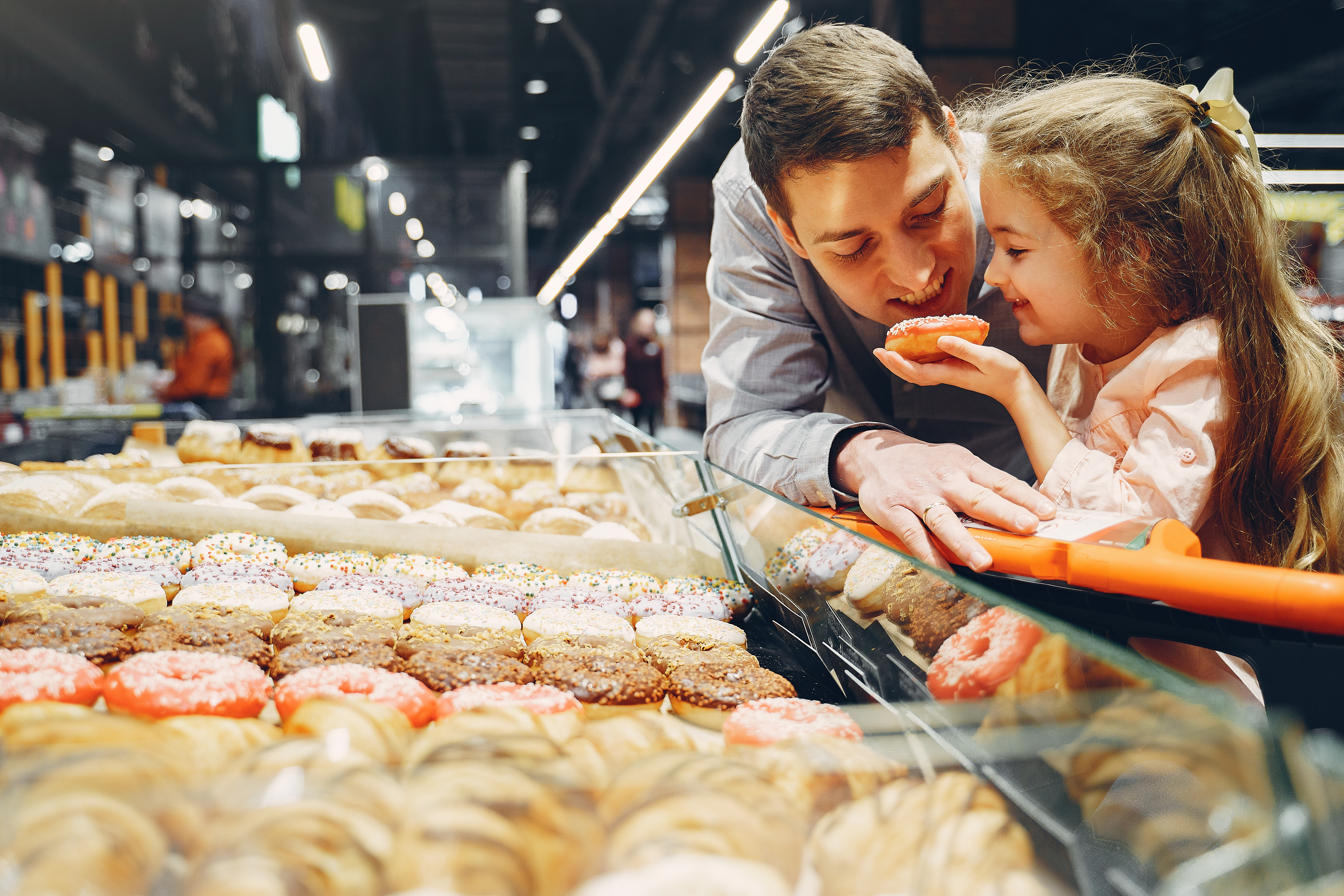 Canva - Father and Daughter Eating Donut