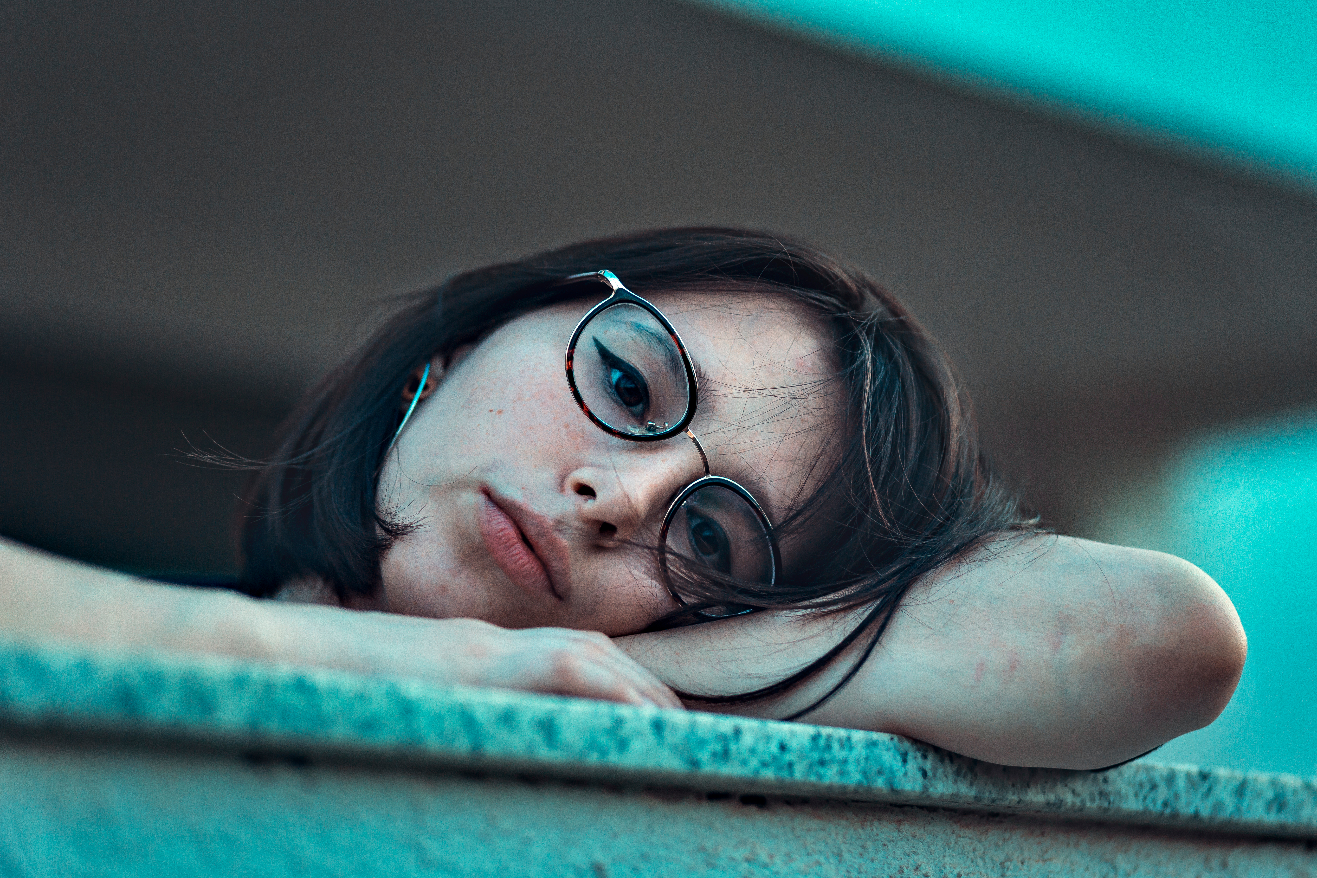 Canva - Photo of Woman in Eyeglasses Resting Her Head on Arm